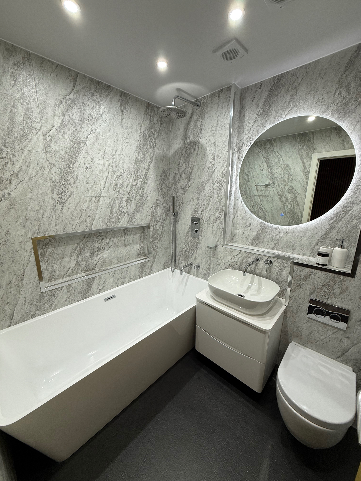 Wet Wall Pros Deluxe bathroom package — bespoke hotel-grade UPVC bathroom with feature marble wall paneling, ambient LED mirror and brass or black designer fittings