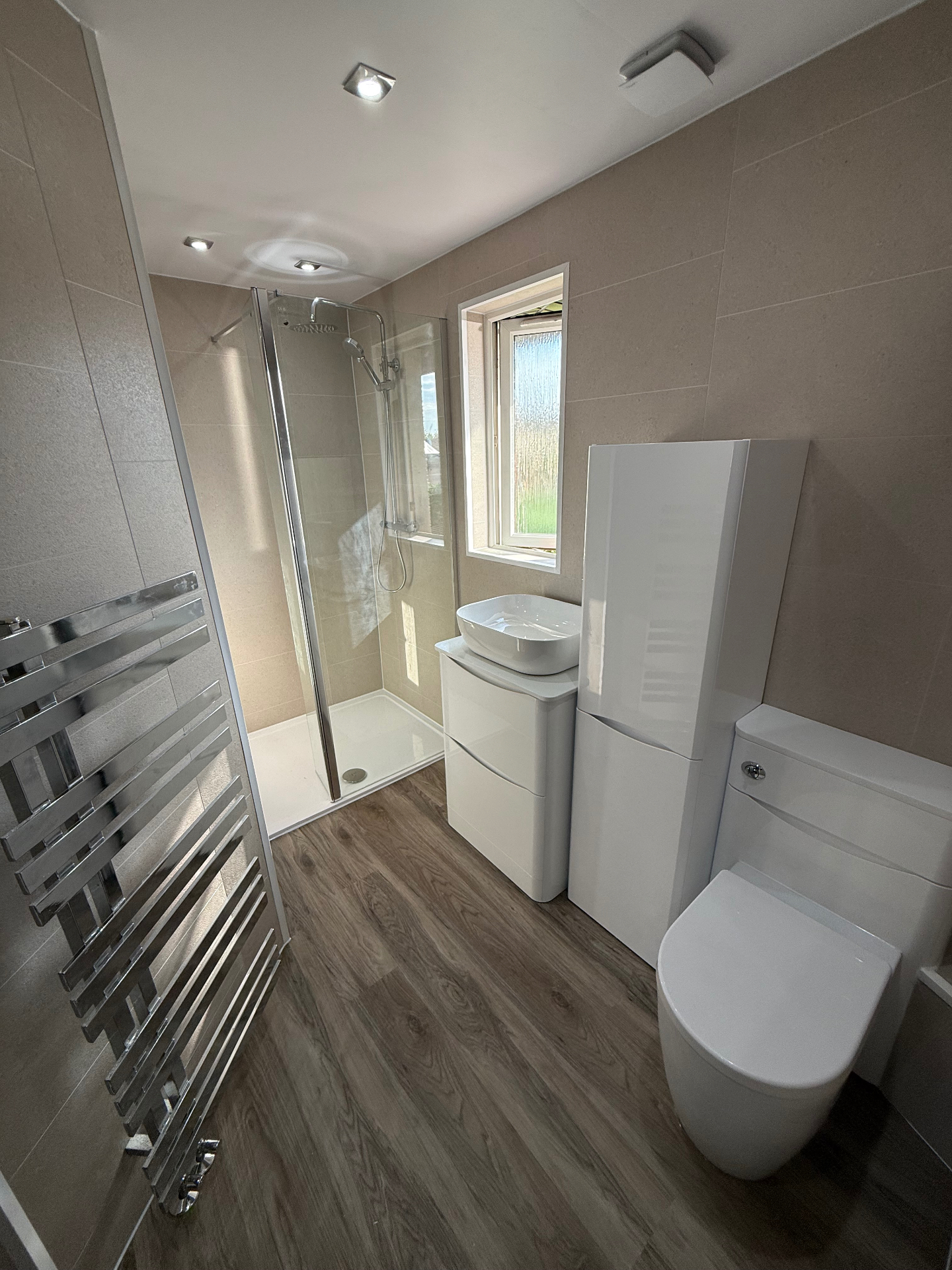 After — modern UPVC wet wall bathroom with walk-in shower, vessel basin and chrome towel rail
