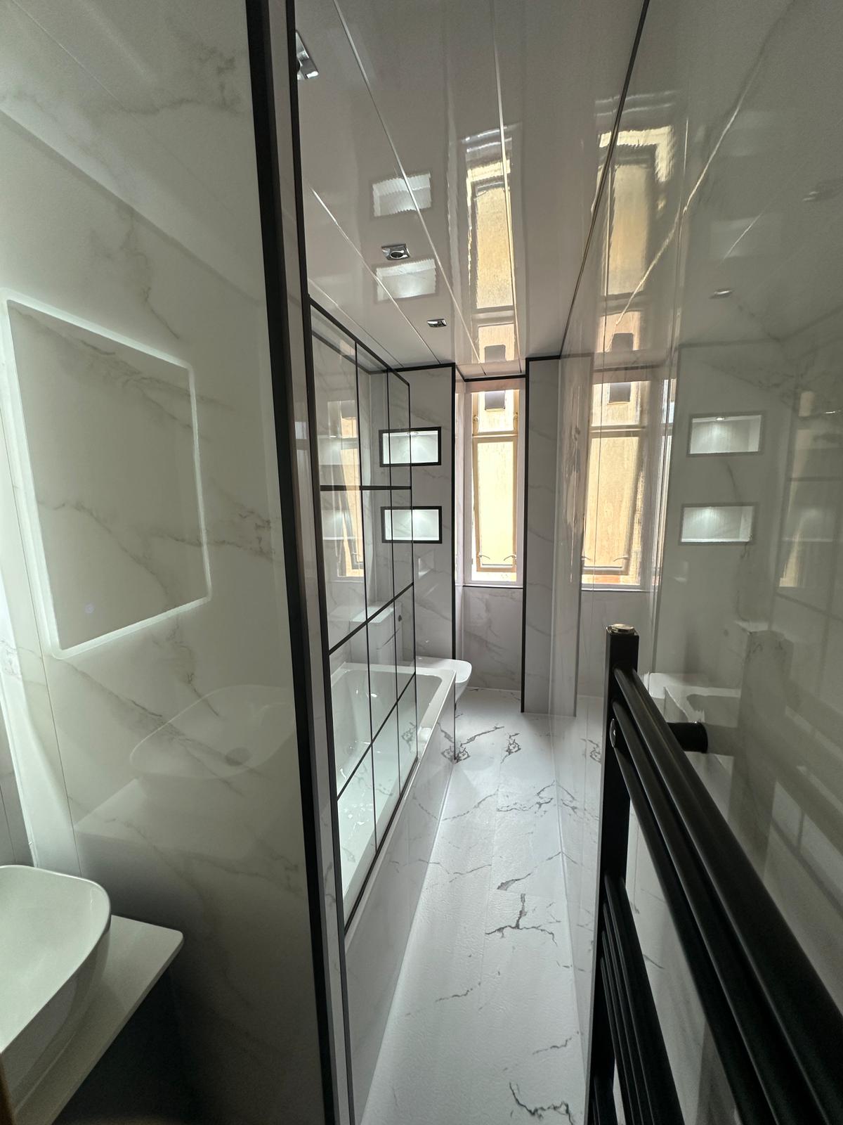 Marble-effect ensuite with black-framed shower screen
